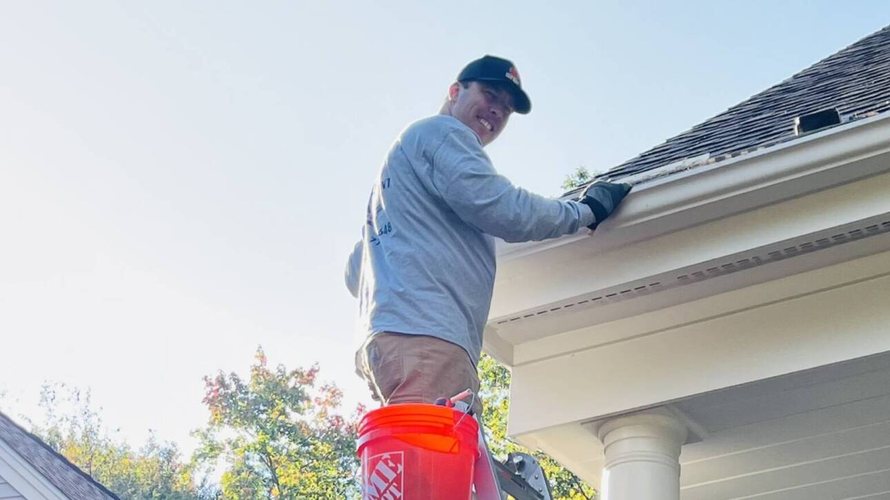 Man is cleaning gutters