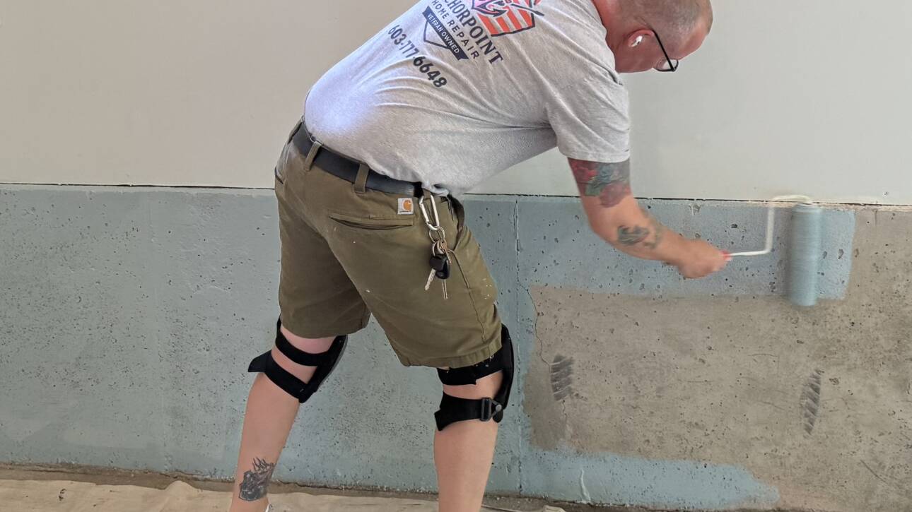 Painter is painting cement wall