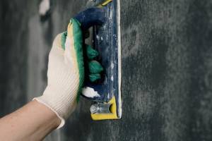 Handyman performing drywall repair in Hampton, NH