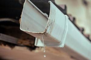 Handyman performing gutter cleaning in Hampton, NH