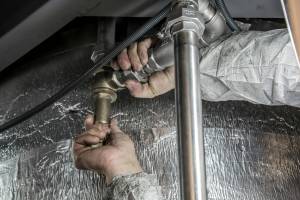 Handyman performing minor plumbing repair in Hampton, NH