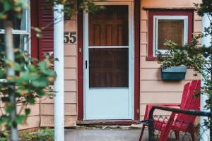 Handyman installing and repairing storm door in Hampton, NH