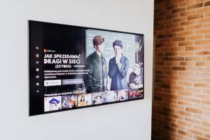 Handyman installing flat screen TV on wall in Hampton, NH