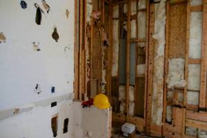 Handyman performing weatherstripping and insulation repair in Hampton, NH