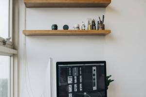 Handyman installing wall shelving in Hampton, NH